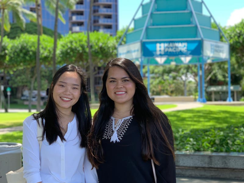 female students standing outside