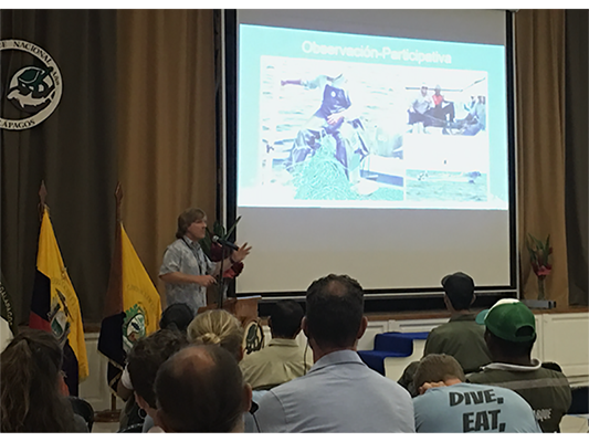 Adam Burke presenting at a 2019 symposium in the Galapagos