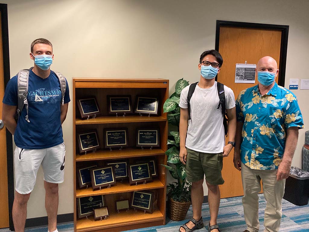 Dorde Zlatanovic, Truong Nguyen, Professor Curt Powley with plaques from HPU's prior contest wins.