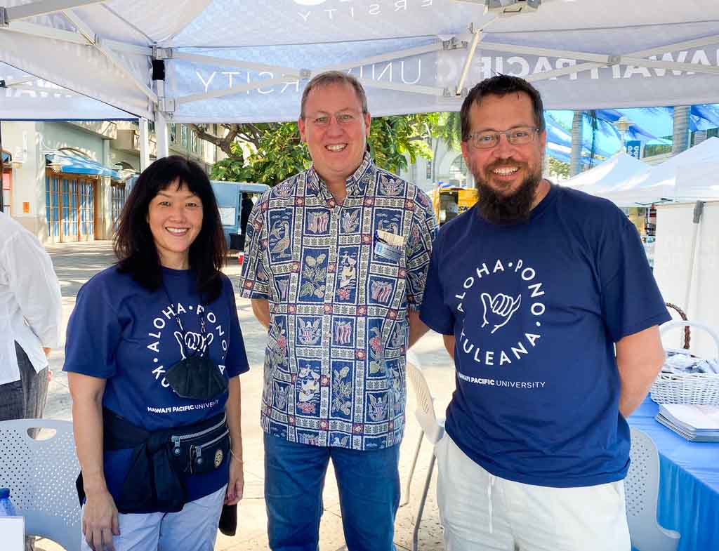 Joe Logan (center) with Greg Grauman and Sara Sato, HPU enrollment management staff