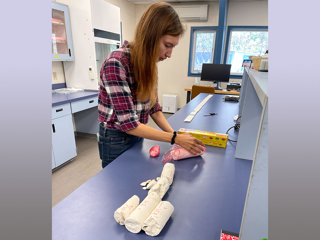 Hannah Whitaker carefully wraps coral cores.