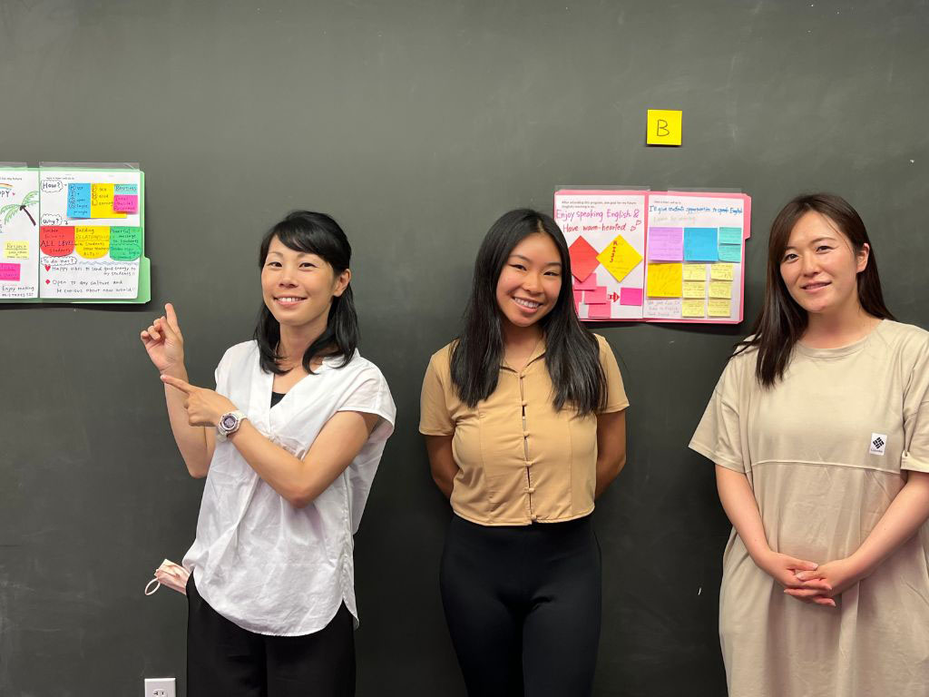 Program participants Minny and Yumi and HPU's Amanda Chhour conducting a poster session.