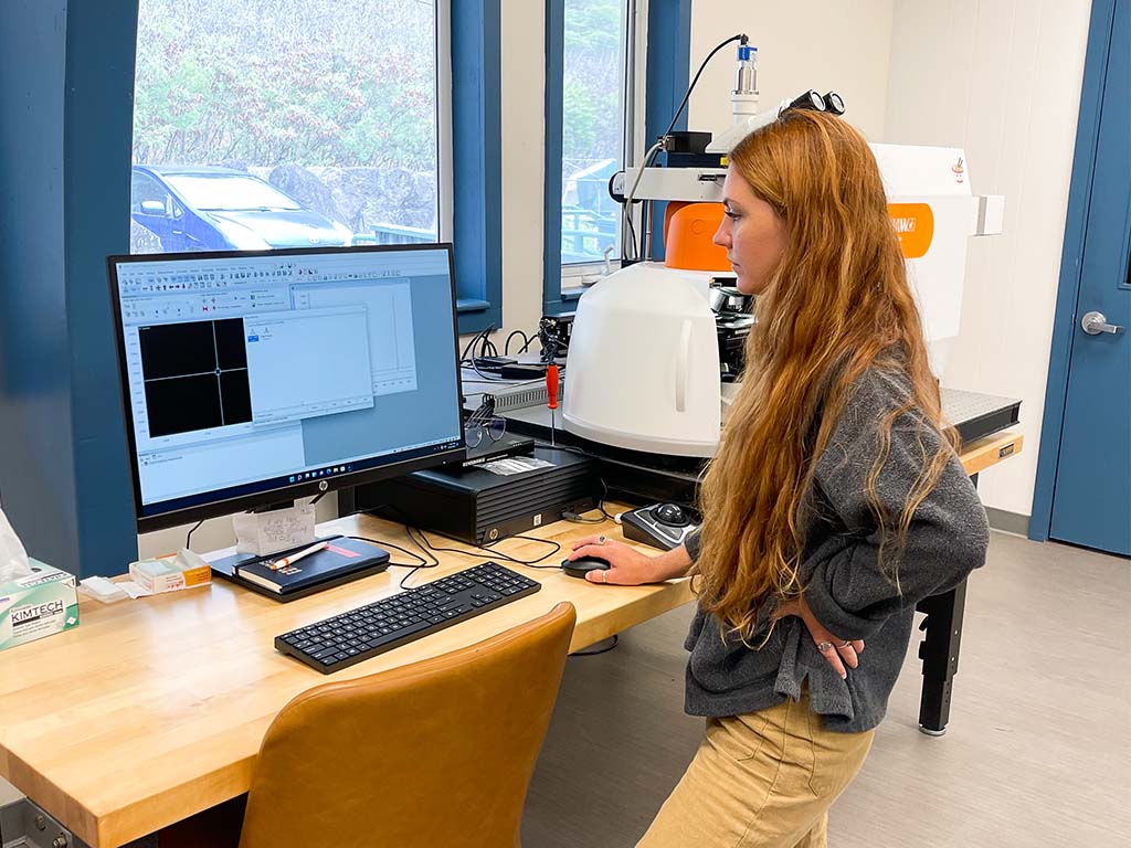 Jessica Hankins conducting coral research on a Raman spectrometer.