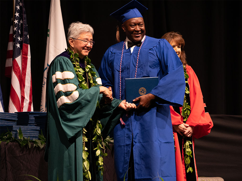 HPU President John Gotanda and HPU Provost Jennifer Walsh with HPU graduate