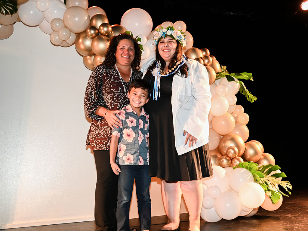 A Bachelor of Science in Nursing graduate celebrating with family at the pinning ceremony