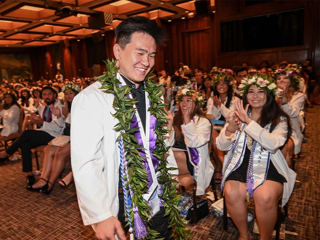 Bachelor of Science in Nursing graduate and undergraduate valedictory speaker Cody Lee celebrates at the pinning ceremony