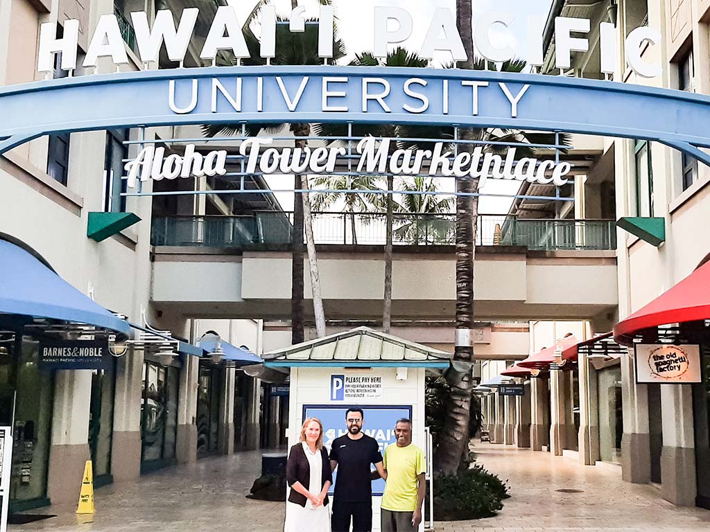 University of Auckland Professor David Sundaram (right) and Senior Lecturer Gabrielle Peko (left) join HPU Assistant Professor Ghazwan Hassna (center) at HPU's Aloha Tower Marketplace