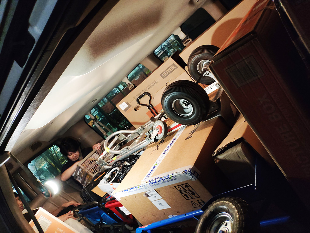 Boxed servers and IT appliances ready to be moved by Ydel Espiritu (left) and Jeremy Nagahama (right)