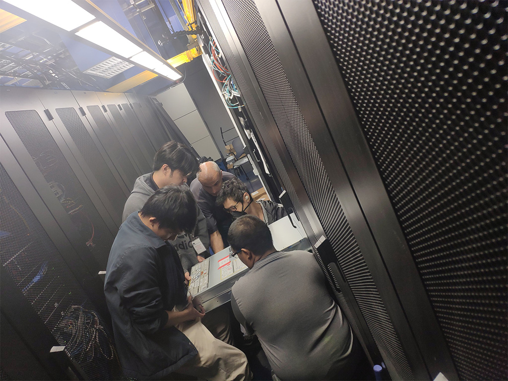 Maneuvering a 75-pound server (clockwise from left to right) - Ydel Espiritu, Jeremy Nagahama, Kornel Osztrovics, Topher Schlund, and Tyler Atiburcio (back to camera)