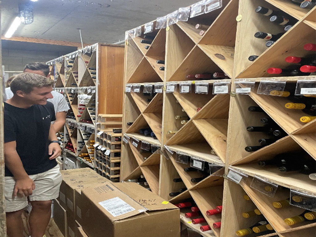 Students tour the Pacific Club wine cellar