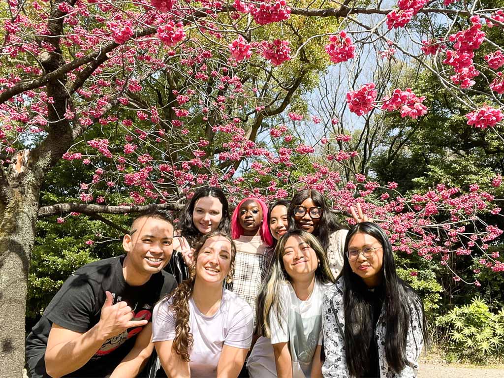 HPU students under plum blossom trees in Tokyo