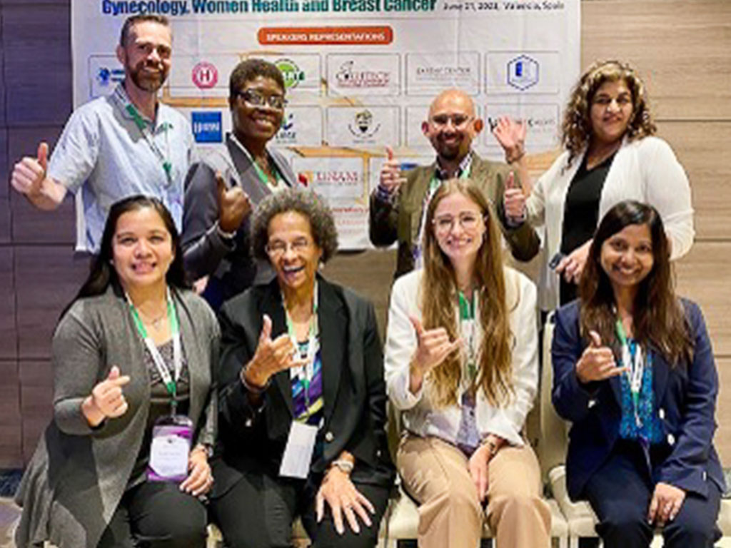 Patricia Burrell (bottom row, second from left) and Leeah Javier (bottom row, first from left) represented HPU at the conference