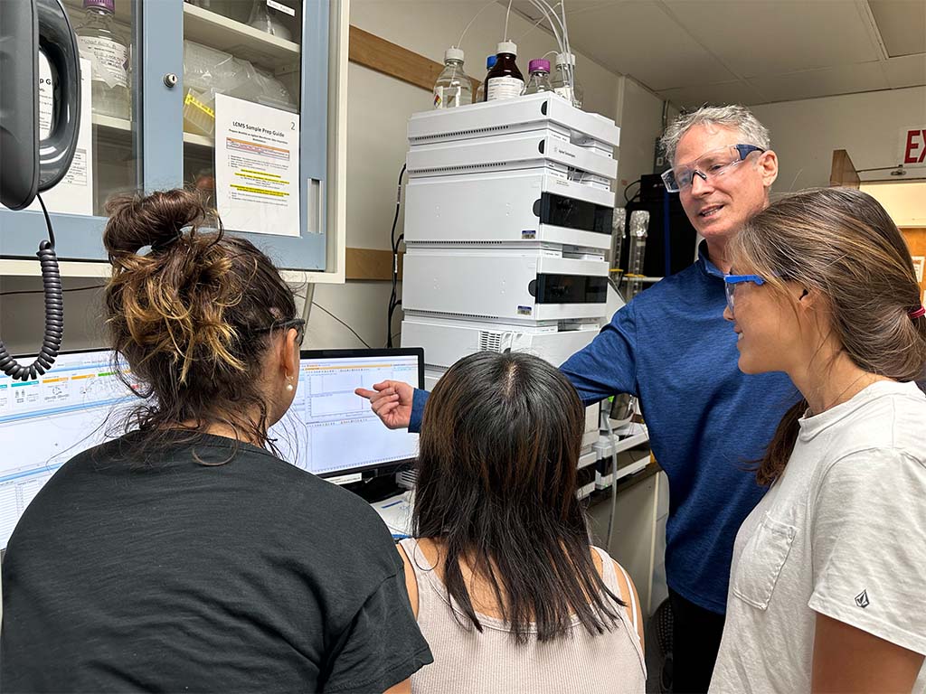 David Horgen in a laboratory with HPU research technicians