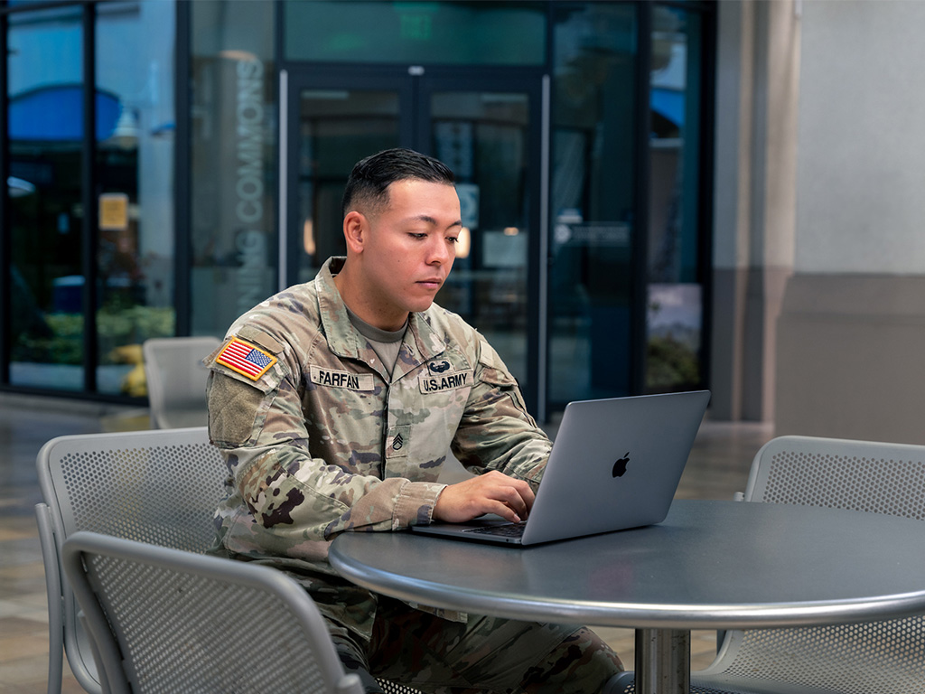 Carlos Farfran studying at the center atrium at HPU's Aloha Tower Marketplace campus