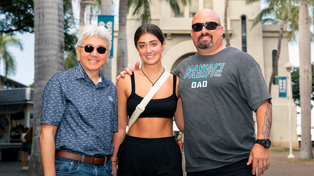 HPU President John Gotanda with a new HPU student and her father