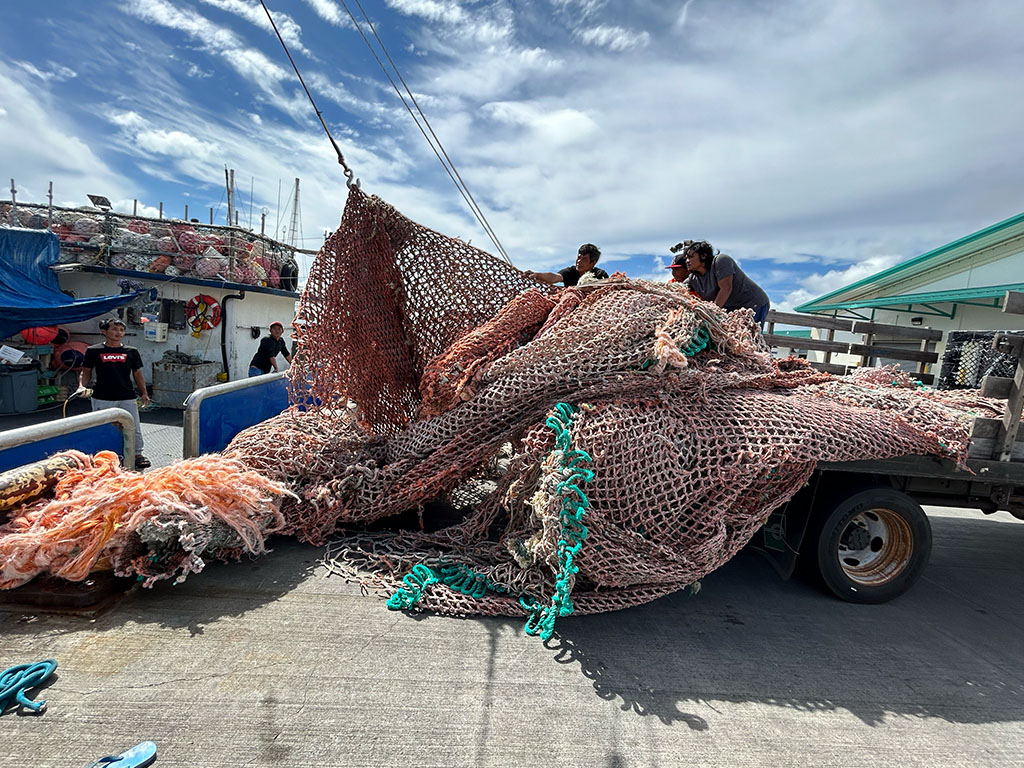 Captain and crew, who are members of the Hawai'i Longline Association, offloading a 2,550 pound net at Pier 38. To date, this is the heaviest derelict fishing gear that has been removed by fishers in the program