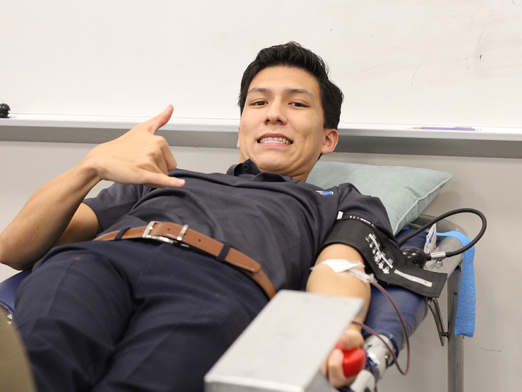 Blaise Babineck donates blood at a recent blood drive