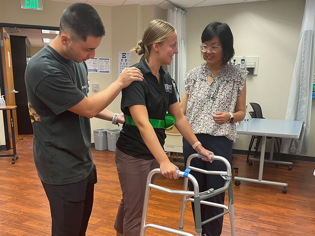 Qing Zhang, DPT, (far right) with Class of 2024 DPT students Daniel Rodriguez and Kennedy Schuelke in the Management of Complex Patients lab