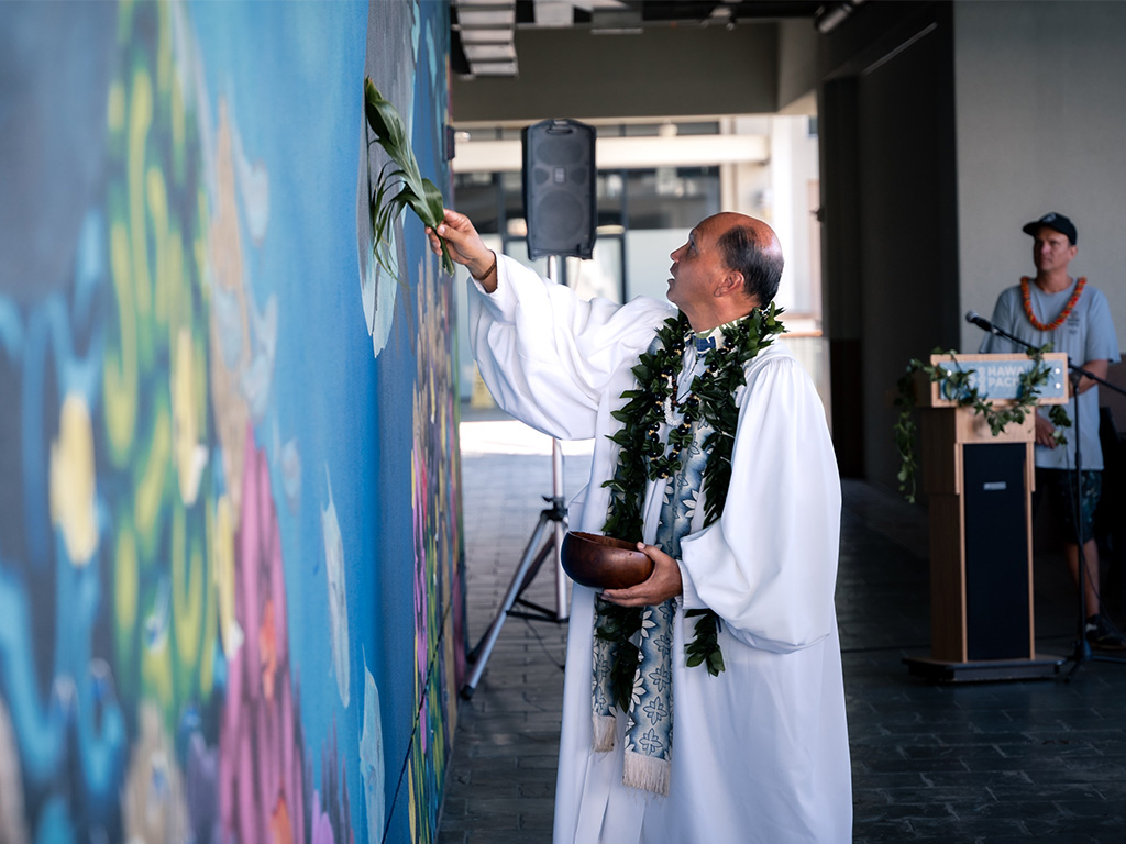 Kahu Kordell C. L. Kekoa blesses the mural on November 1, 2023