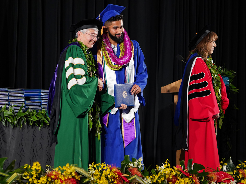 A graduate receives his degree at the graduation ceremony