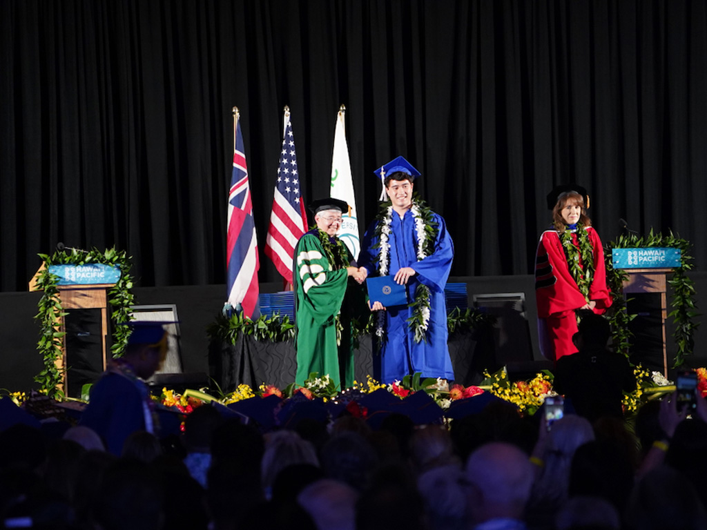 HPU President John Gotanda and HPU Senior Vice President and Provost Jennifer Walsh on stage at the graduation ceremony