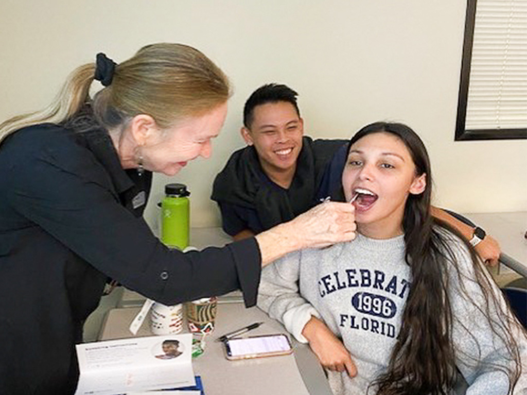 Joy Bliss with HPU students Kayla Sistrunk and Kyler Yee obtaining a swab at the 'Be the Match' donor event