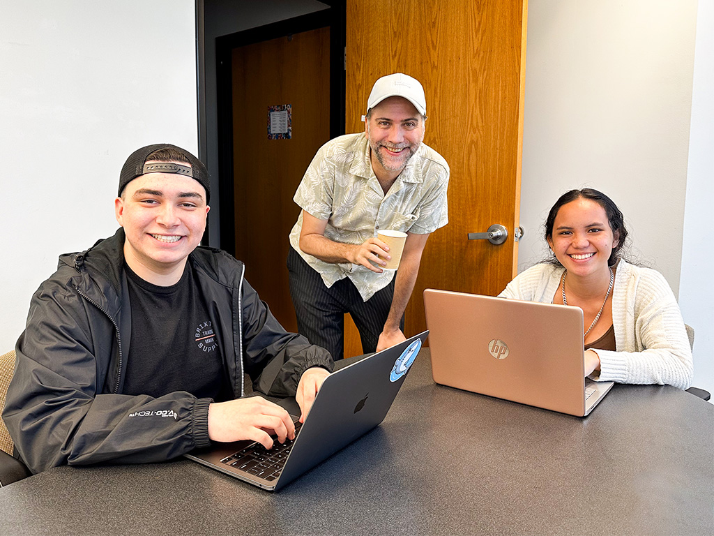 HPU students Orion Hefling (left) and Aileen Kekumu (right) with their English professor Julian Bukalski (center) at the Ho'oko offices