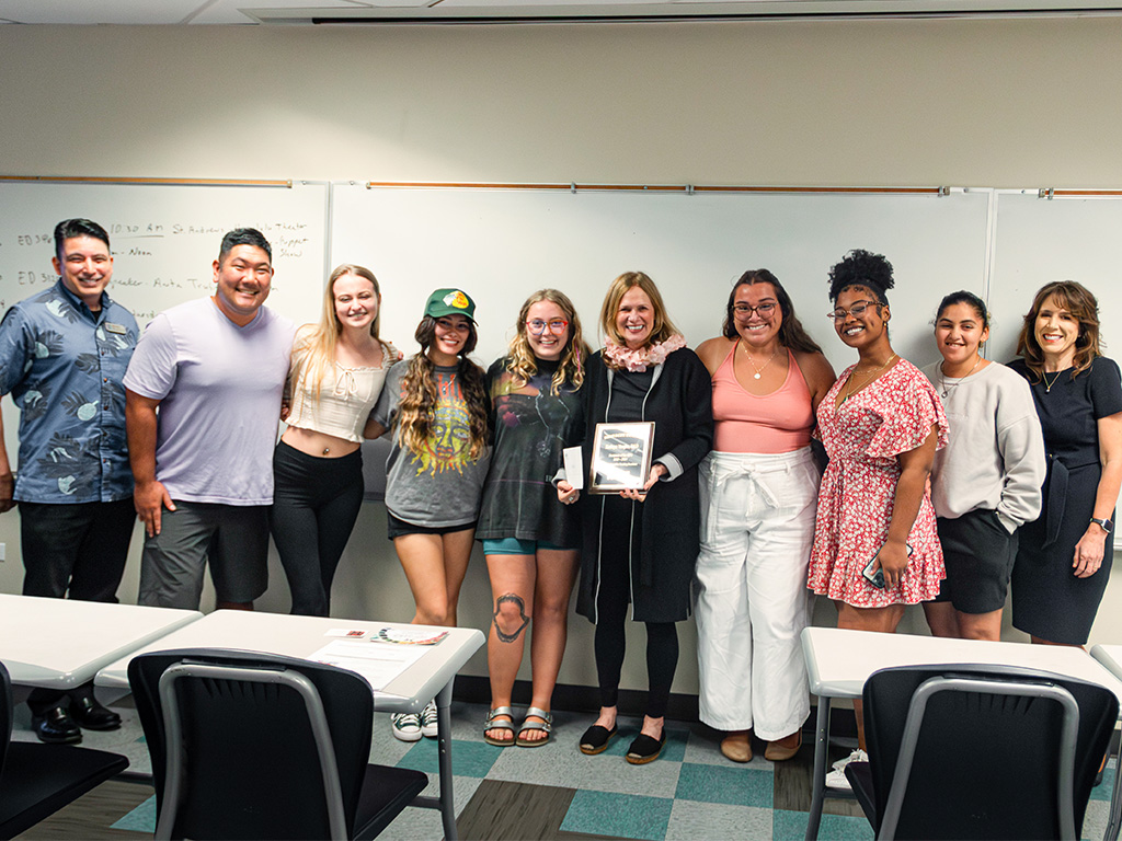 HPU students pose with their professor, Kathryn Vaughn (center), in their elementary education classroom with Provost Jennifer Walsh (right) and Dean Mani Sehgal (left)