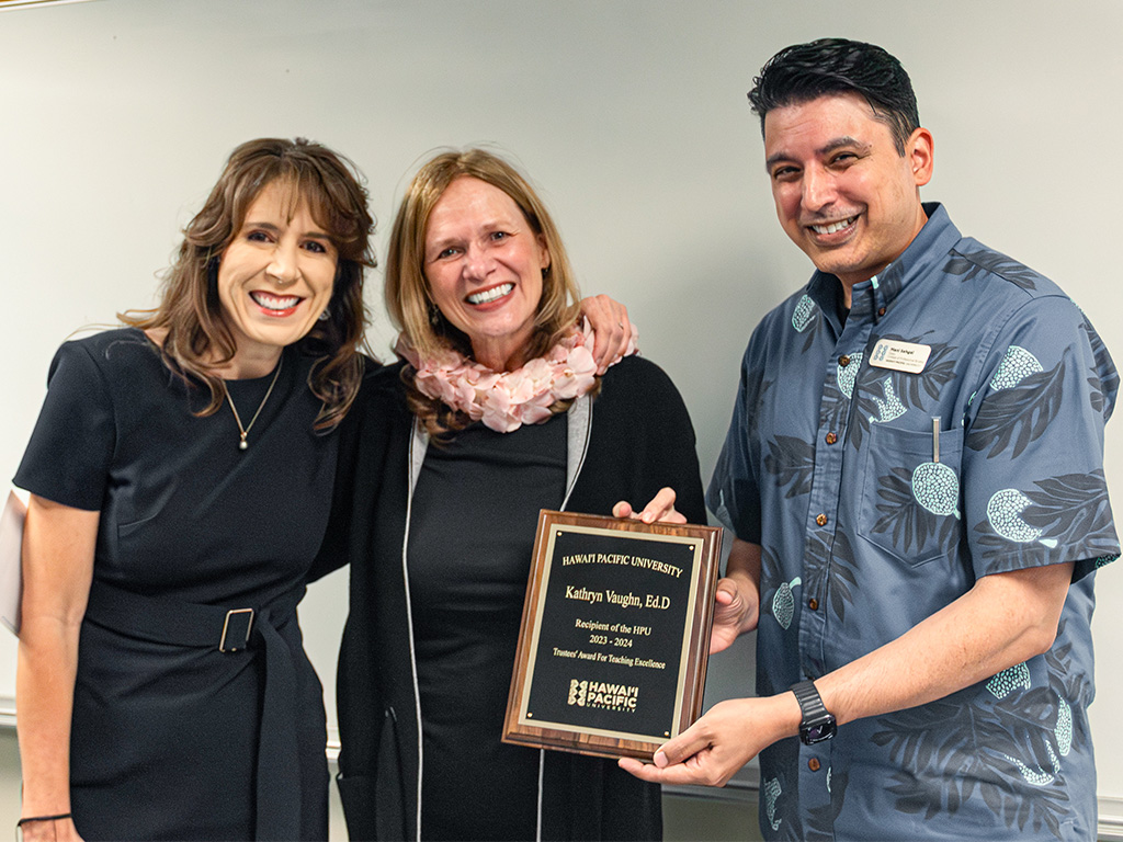 HPU 2024 Teacher of the Year award winner Kathryn Vaughn (center) with Provost Jennifer Walsh and Dean Mani Sehgal