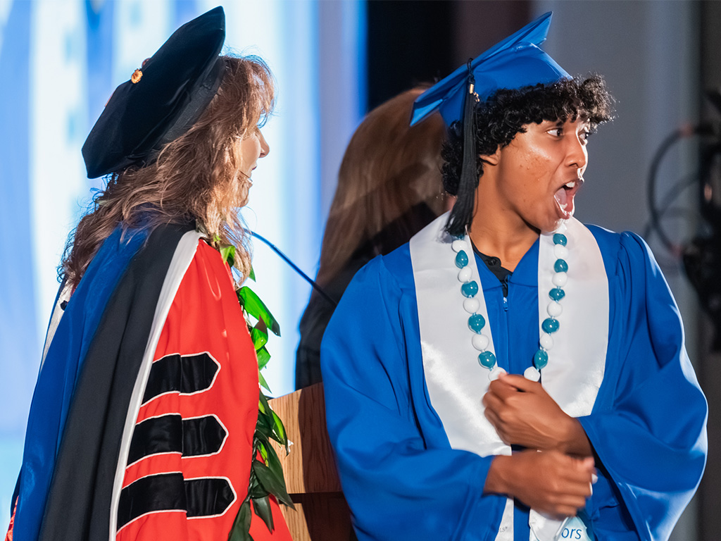 HPU Senior Vice President and Provost Jennifer Walsh with an HPU student after receiving his degree