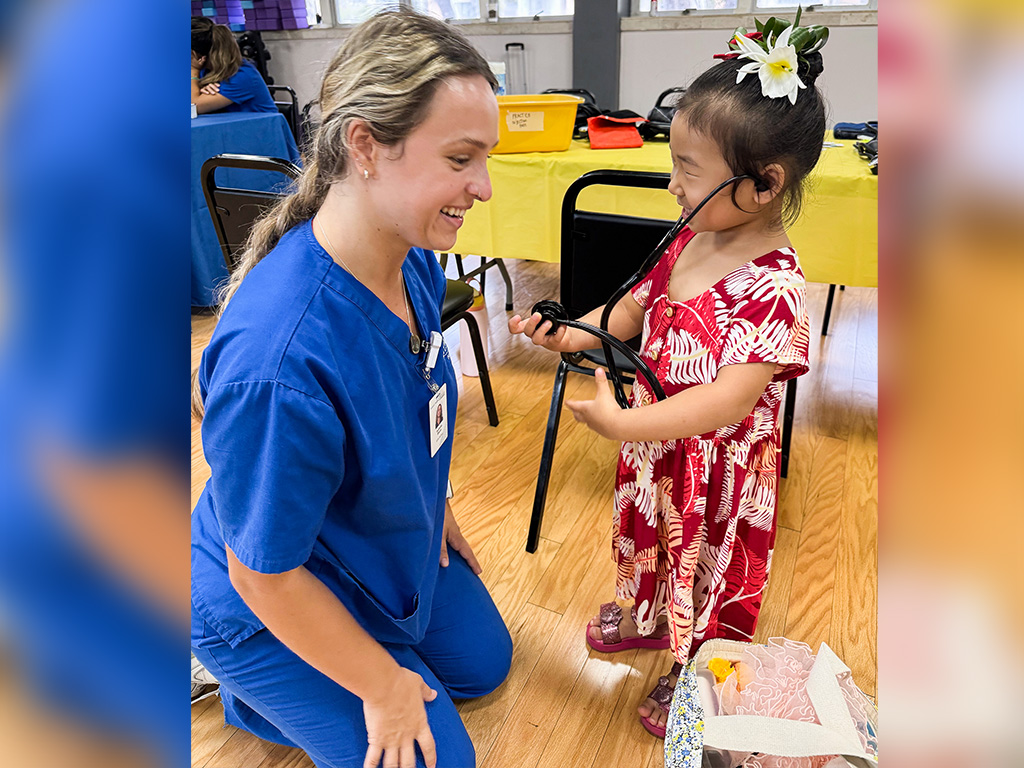An HPU nursing student and a child at the annual 'Healthy Kids Day' event at the Nu'uanu YMCA
