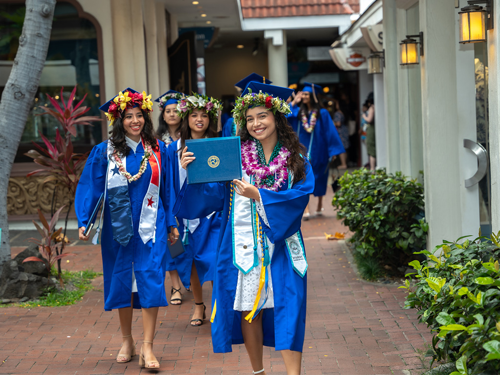 HPU graduates make their way to the Duke Paoa Kahanamoku Lagoon, just steps away from the graduation stage