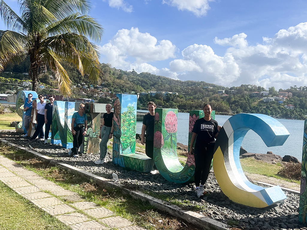 OTD students and faculty members posed with the St. Lucia mural, spanning approximately 50 feet and standing six feet tall, the only official sign on the island