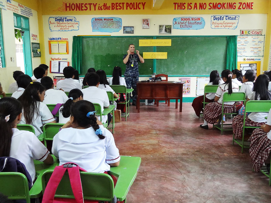 Zach Drury teaching first aid to a classroom of students in the Philippines