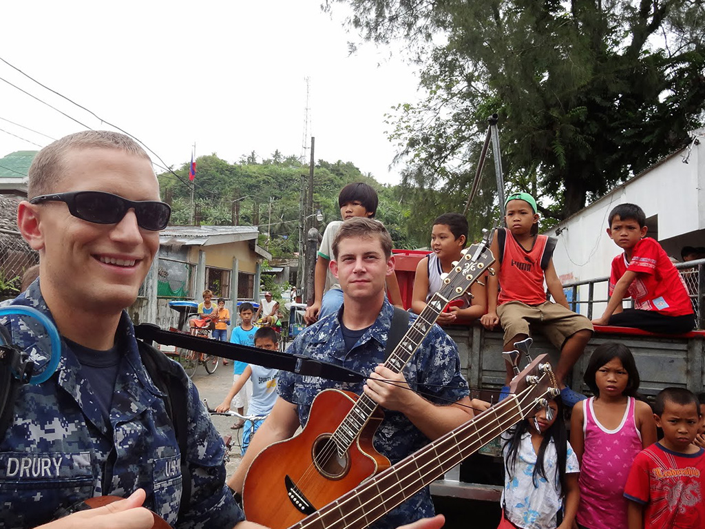 Zach Drury (left) with Navy bandmate, celebrating music and connection in Southeast Asia