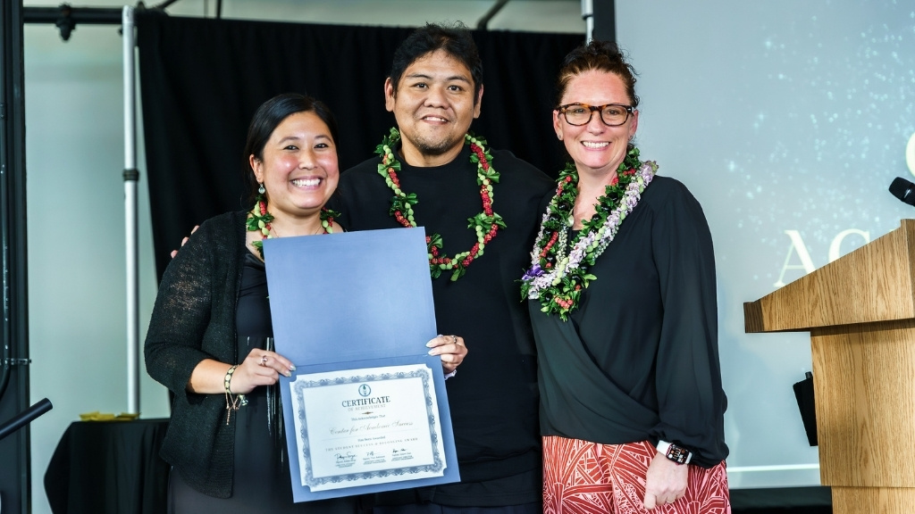 On behalf of the Center for Academic Success, Drs. Erica Chun and Dexter Asuncion accept the Student Success & Belonging Award from Director of Student Engagement Robyn Serge