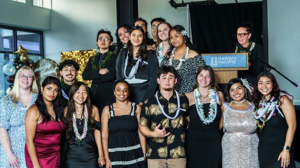 Campus Activities Board recognizes its network of active general members who assisted with hosting events throughout the year. Nevaeh Guillen (on stage, center) was recognized as Member of the Year. Left to right, bottom row: Raelynn Ruddell, Carmen Rovira Moreno, Justin Alday, Kanon Morimoto, Trinity Bradford, Jonah Stokes, Kayleigh Mosher, Ziomara Ramos, Princess Paradise Pascua. On stage, front row: Dyson Chee, Makayla Martinez, Nevaeh Guillen, Rebecca Raynoschek, Ericka Gabriel Lumbo. On stage, back row: Tian Robinson, An Vo, Robyn Serge