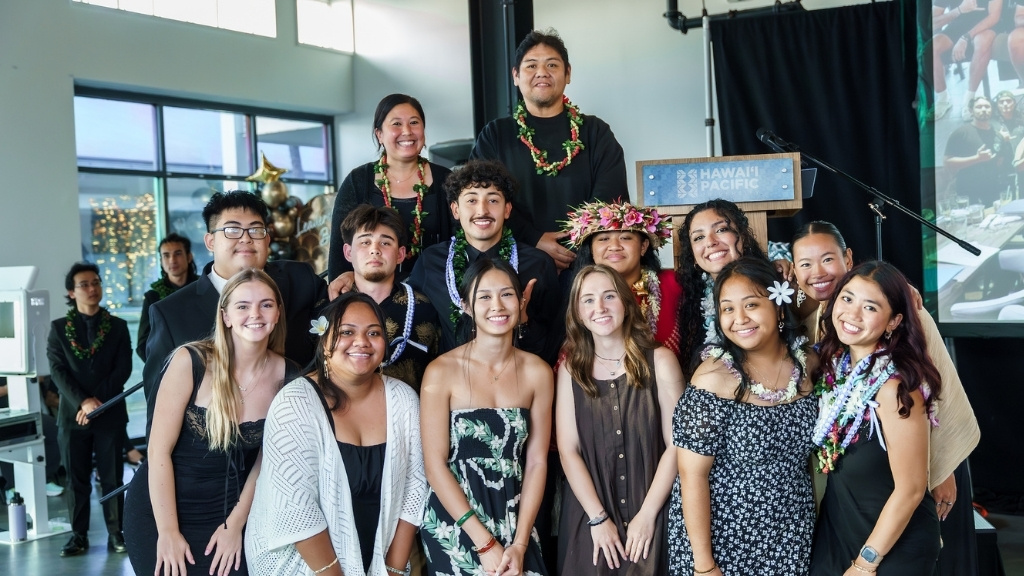 The Peer Mentor team is recognized for fostering a sense of student belonging and success at HPU. Left to right, front row: Caitlin Duncan, Leasuone Vaeoso, Emily Nguyen, Leigha Dick, Ericka Gabriel Lumbo, Princess Paradise Pascua. Back row: An Vo, Jonah Stokes, Justin Alday, Aleiah Leilua-Toloai, Makayla Martinez, Dana Nguyen. On stage: Drs. Erica Chun and Dexter Asuncion