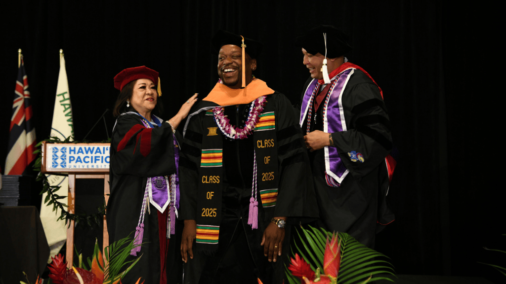 A proud moment: ceremonial hooding of DNP graduate Marino Robinson by School of Nursing Dean and Professor Edna Magpantay-Monroe, Ed.D., APRN, CMDCP, and Associate Professor Vincent Pair, DNP, PMHNP-BC, FNP-BC 