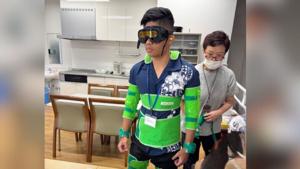 Student Jejomar Balanay experiencing the Geriatric Simulation suit