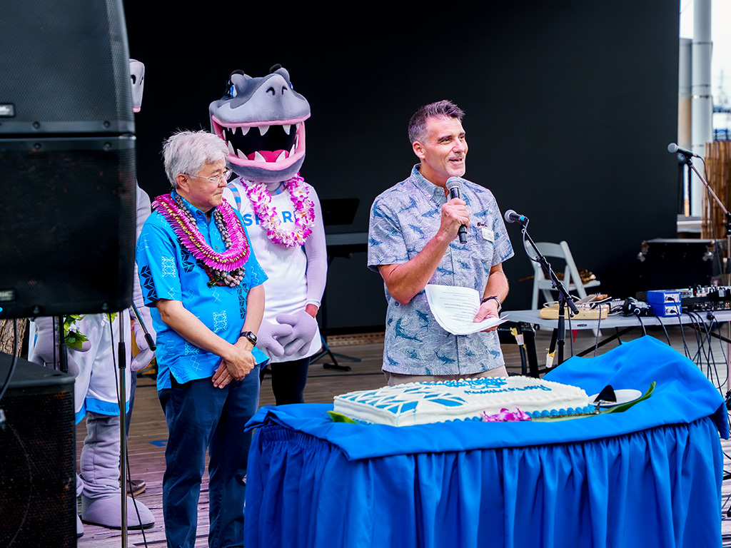 Jeffrey Rich welcomed HPU President John Gotanda to the stage to cut the cake