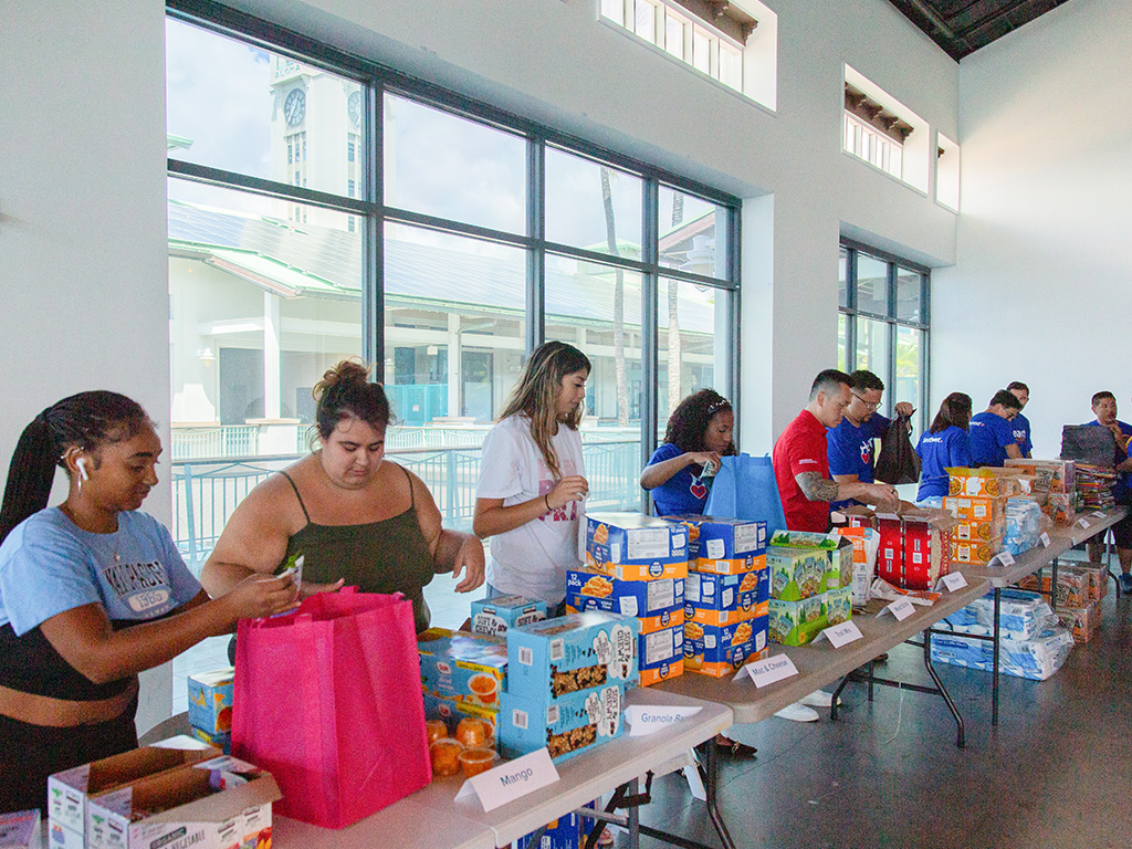 HPU students working together to create 100 kits for distribution throughout the semester