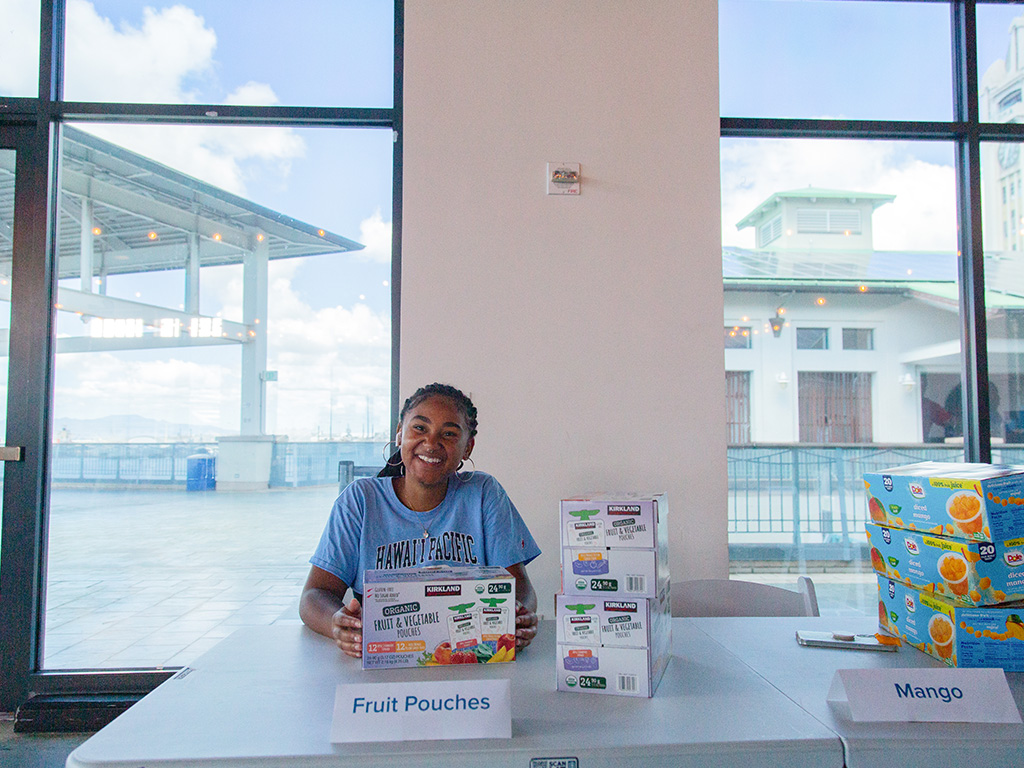 An HPU student preparing Campus Care Kits