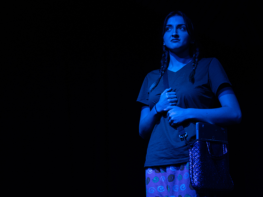 The production was staged under dramatic and often moody lighting