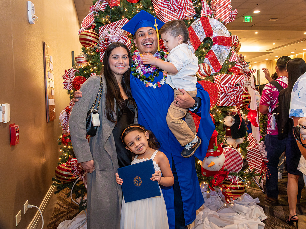 An HPU graduate and his family celebrate at the end of the commencement ceremony