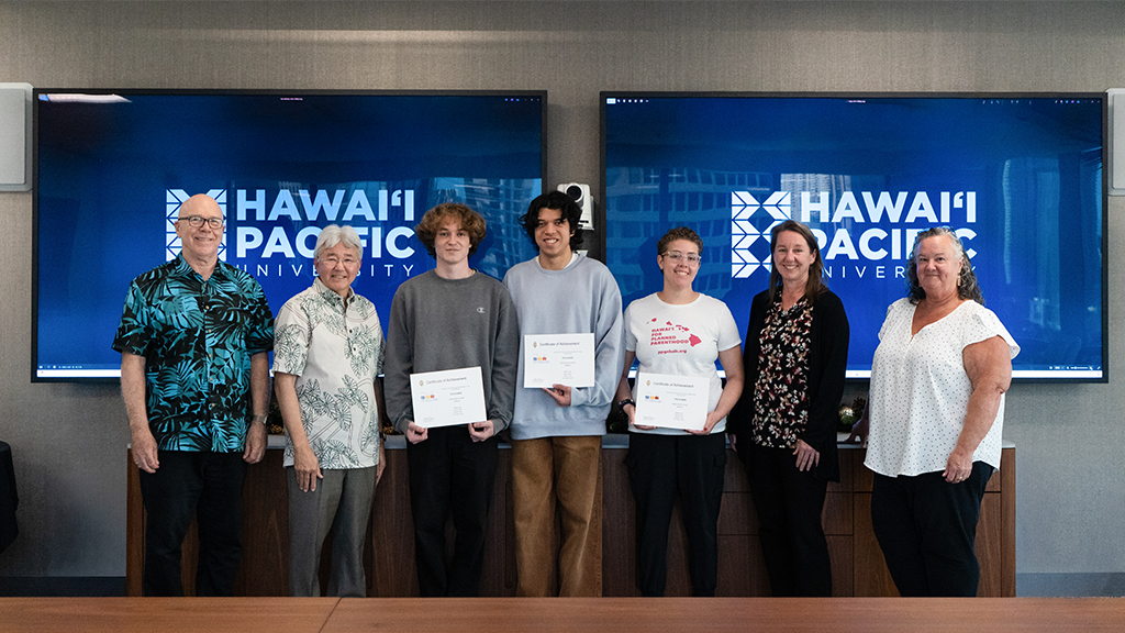 HPU Division I Team #00FF00, pictured left to right: HPU Associate Professor Curt Powley; HPU President John Gotanda; team members Joshua Leonard, Matthew Holck, and Keʻalohi Young; HPU Acting Provost Brenda Jensen; and HPU Acting Dean of the College of Natural and Computational Sciences Carrie Jones