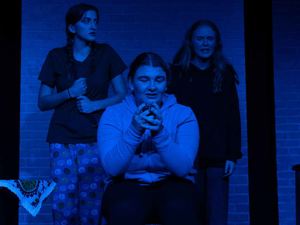 The production was staged under dramatic and often moody lighting