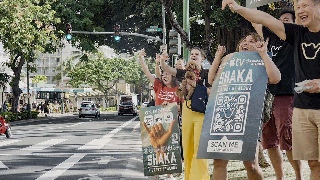 Filmmakers shaka to passing cars in Waikiki to celebrate the release of 'Shaka, A Story of Aloha' (Rebecca Teresia is second from left)