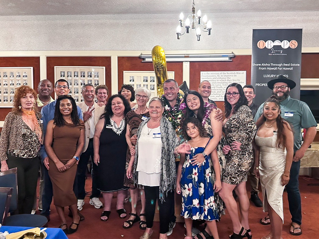 Ben Eger (center) at his brokerage anniversary celebration in 2025