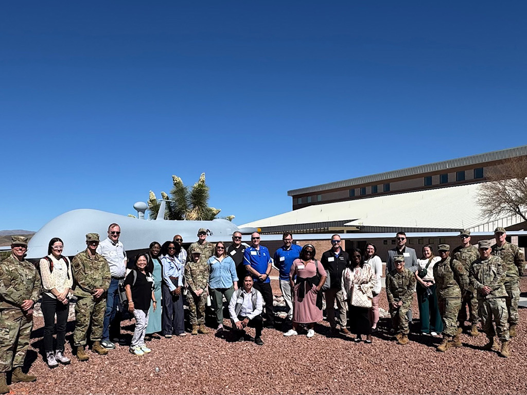 Healthcare participants in front of a fighter jet static display